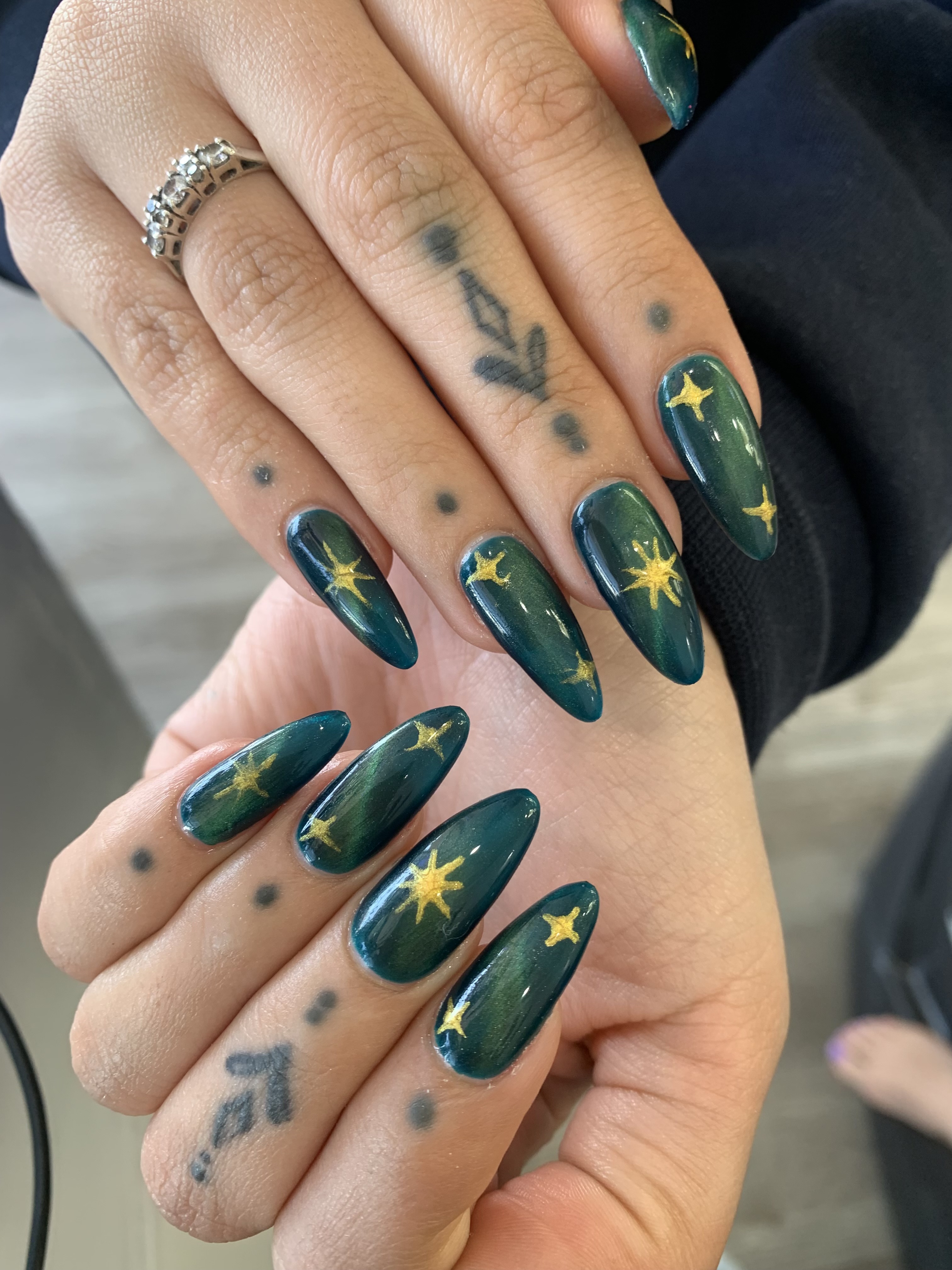 Emerald green nails with gold stars